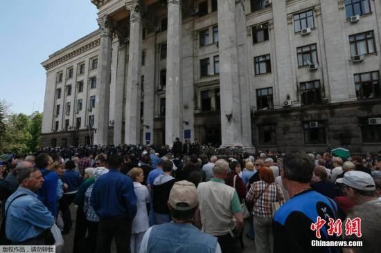 当地时间5月3日，乌克兰敖德萨，民众向当地工会大楼献花。悼念在5月2日的冲突中，工会大楼起火造成42死亡。